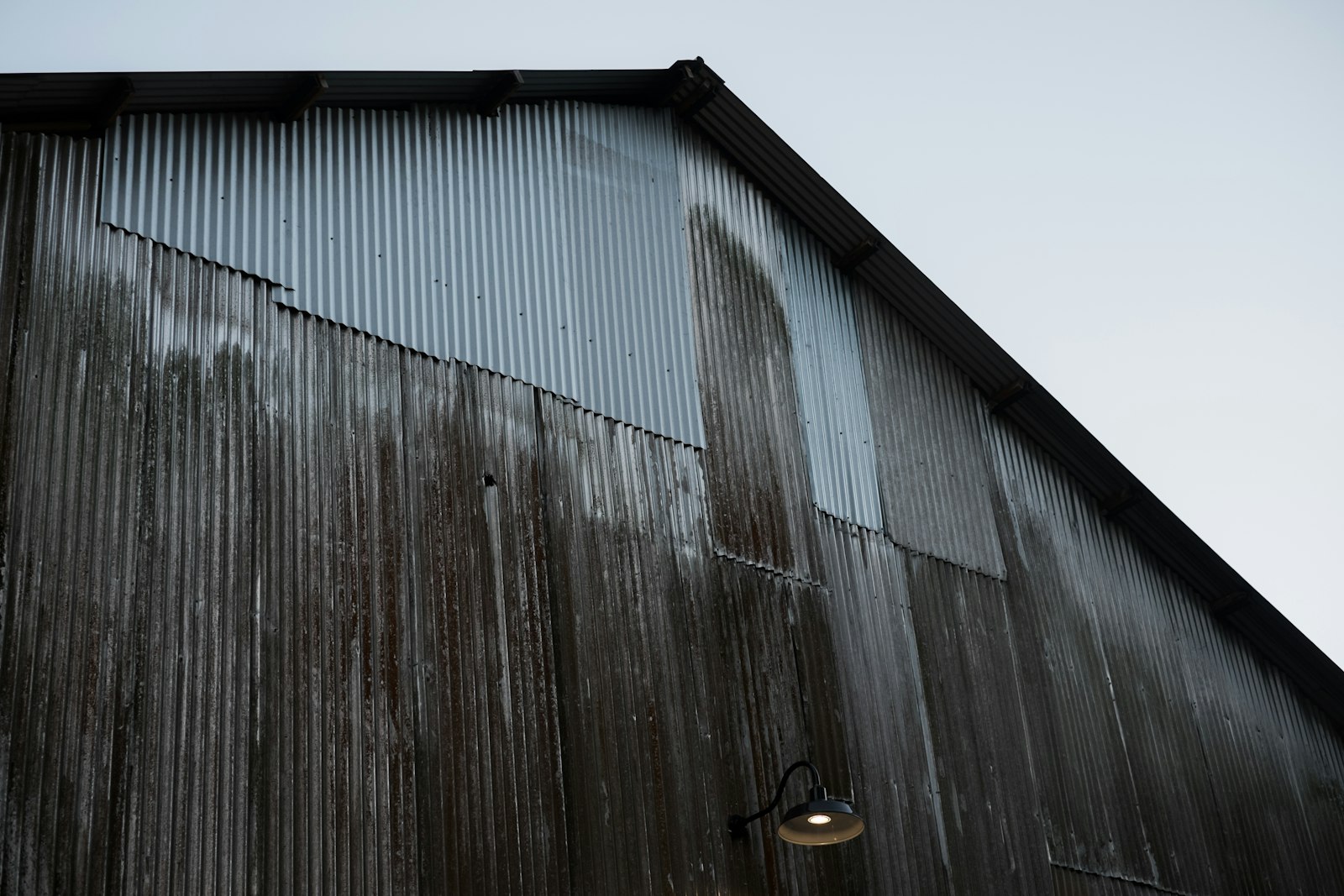 Building cladding showing weathering and organic growth