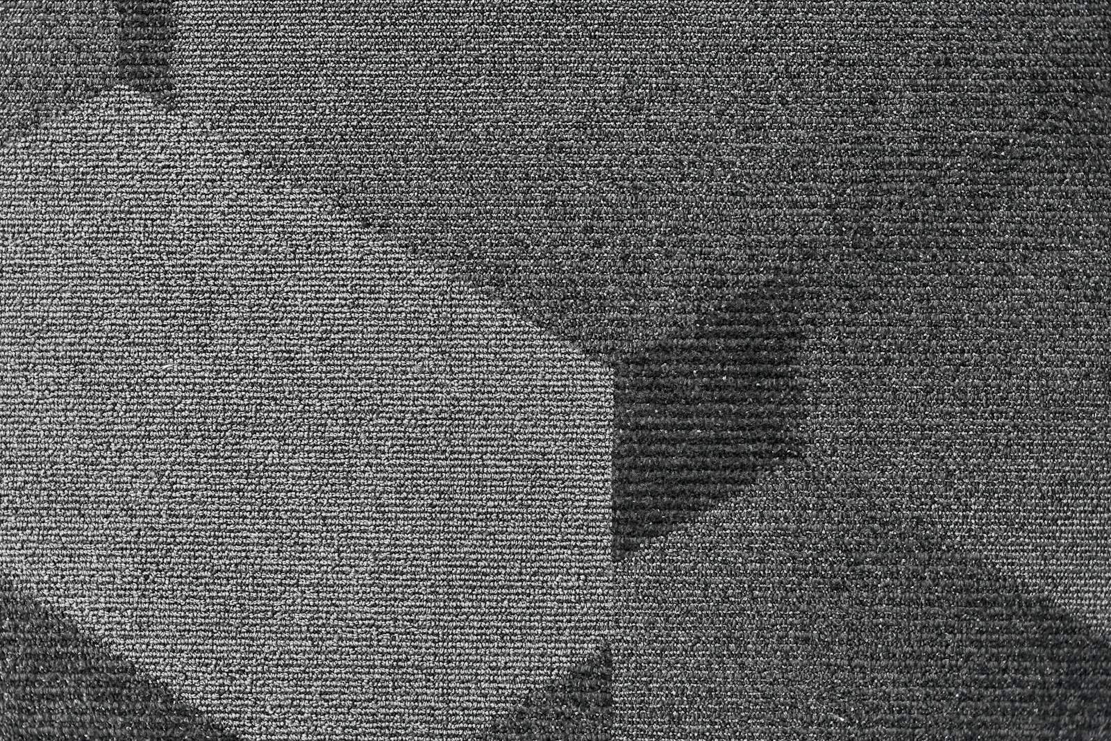 Commercial carpet tiles showing the pile that traps grit in traffic lanes